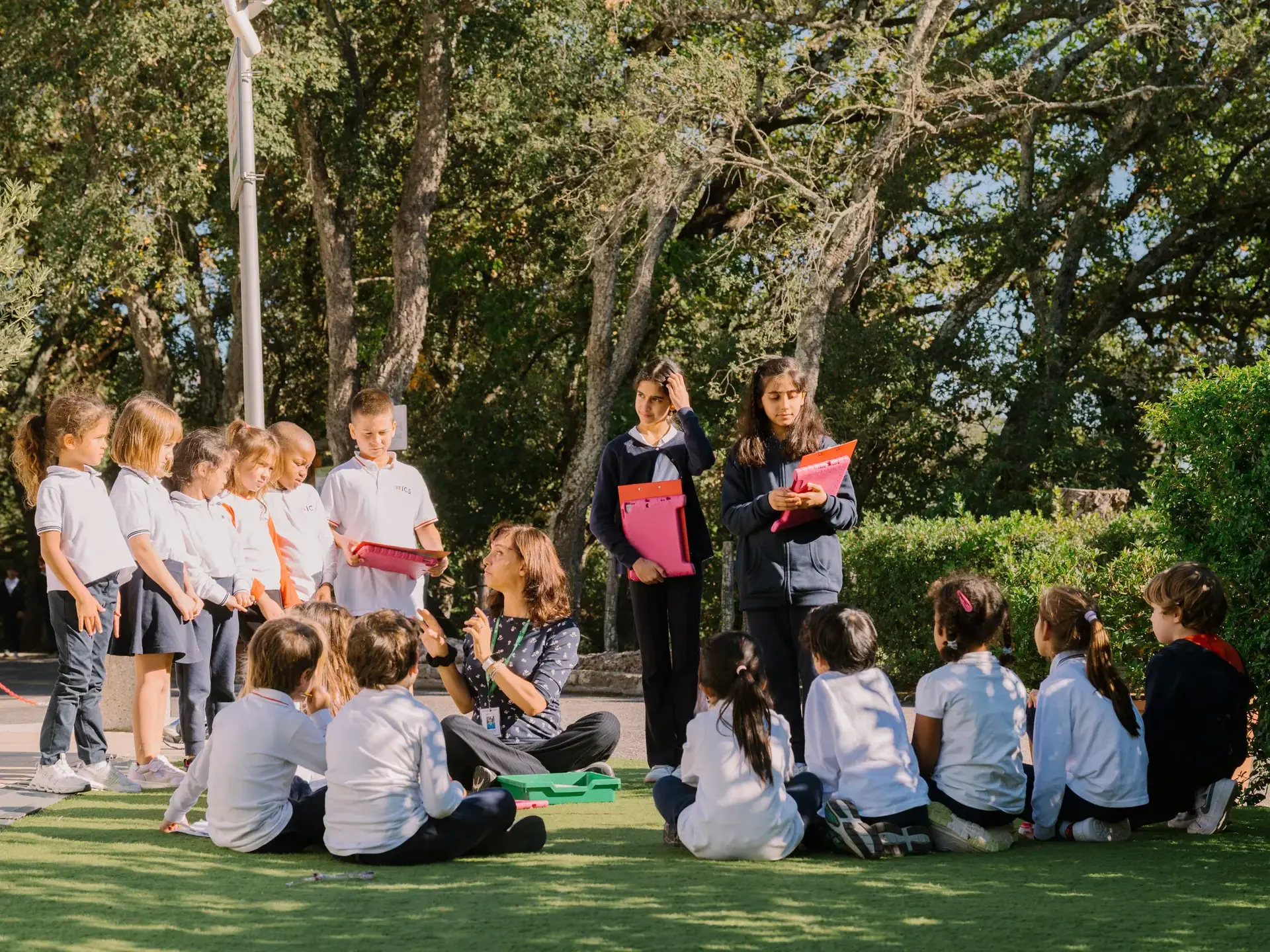 students gathered outdoors with a teacher during an outdoor learning activity at rome international school