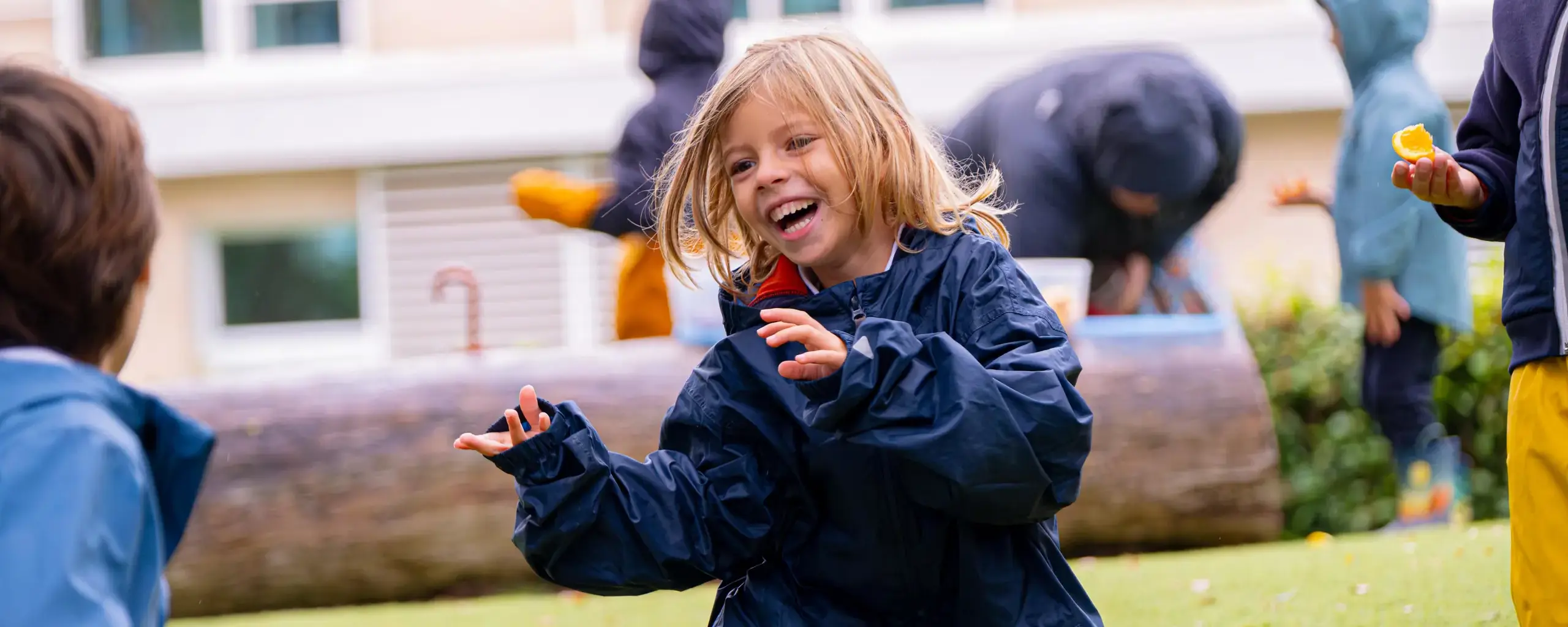 Student smiling playing with peers