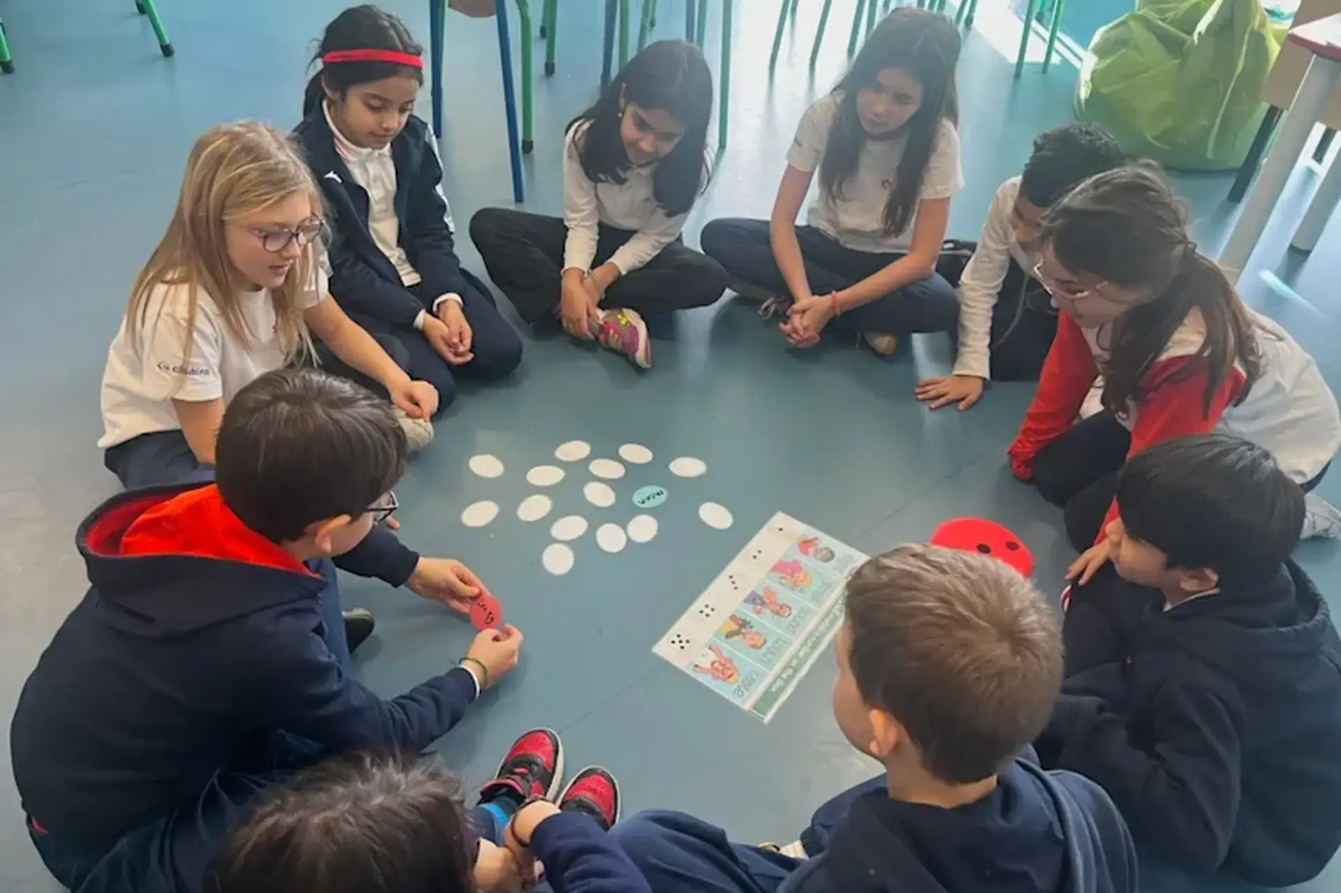 students seated around a table playing a game together.