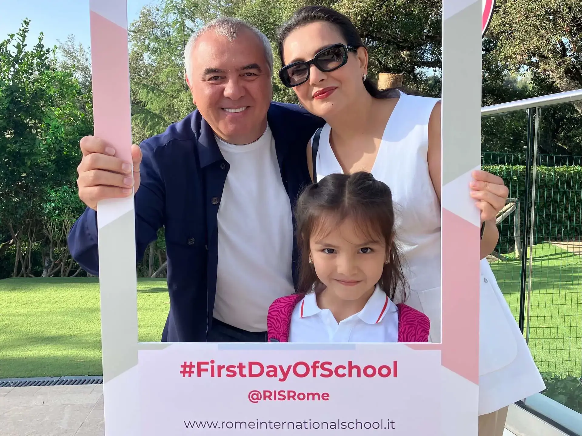 family posing together for a first day of school photo