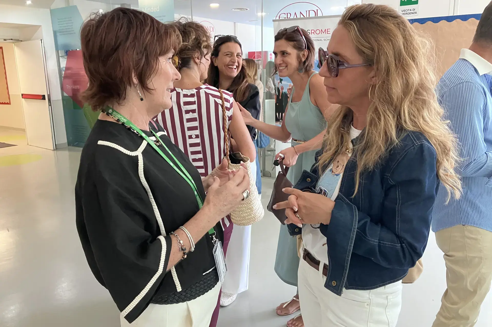 parents chatting and greeting each other in the school hallway on the first day at rome international school
