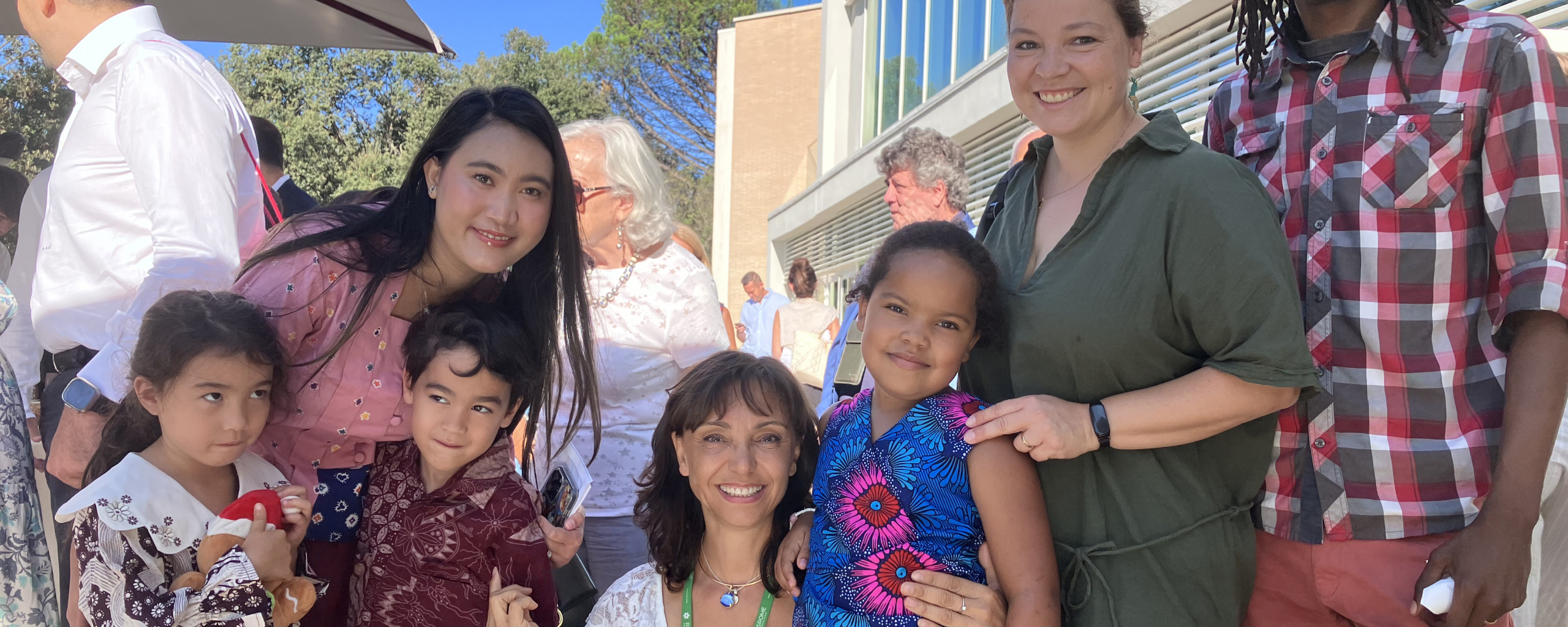 families and children posing together outdoors at a rome international school event