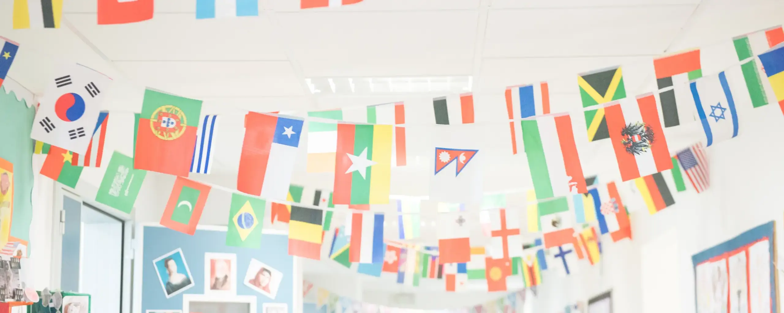classroom wall decorated with international flags