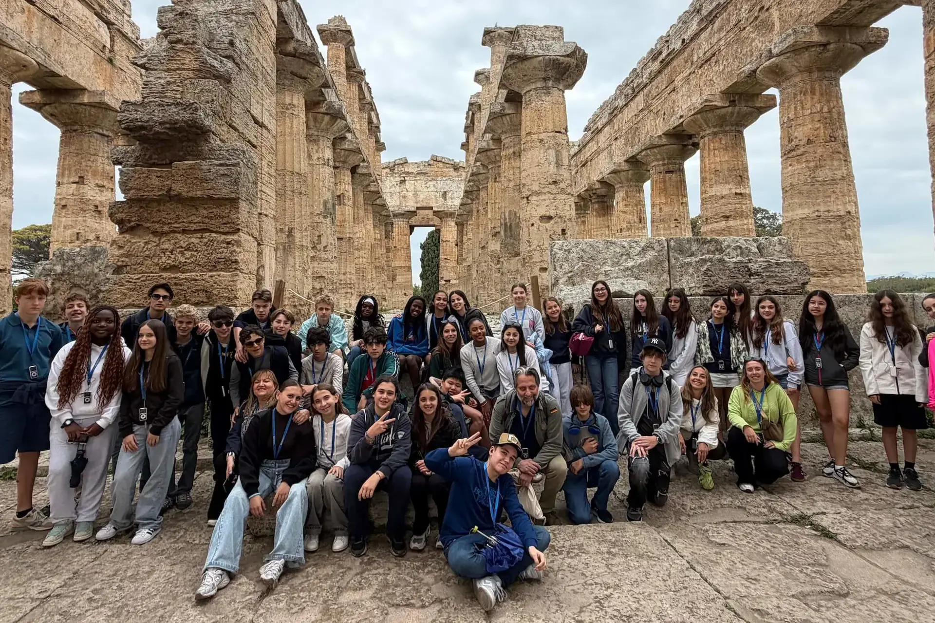 Students at an ancient roman temple ruin.
